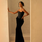 Elegant black corset gown featured in a stylish maxi dress for modern fashion enthusiasts