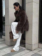 Thickened faux fur mid-length Langry fashion coat with brown fur, white pants, tan shoes