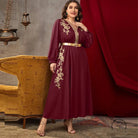 Maroon long-sleeved A-line dress with gold floral embroidery and metallic belt
