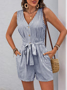 Sleeveless navy and white striped romper with pockets, fashionably designed for summer wear