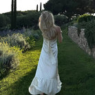 Elegant polka dot satin dress with halter straps and ruffled hem