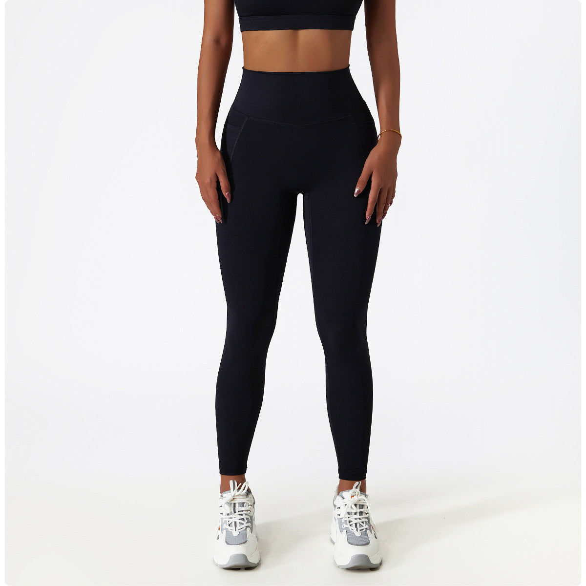 Black high-waisted leggings paired with white sneakers, perfect for athleisure fashion ملابس