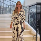 Woman in high waist floral patterned jumpsuit for summer office fashion