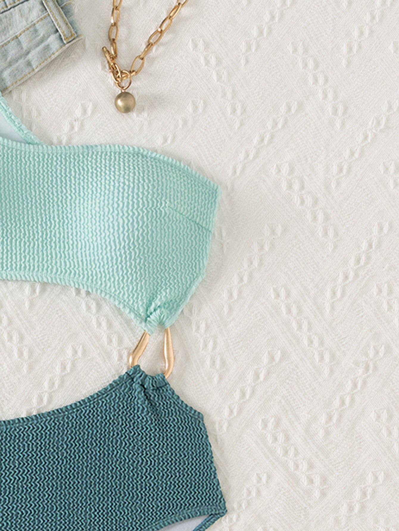 Mint and teal knitted fabric connected by gold hardware in a Stunning Hollow Out Bikini