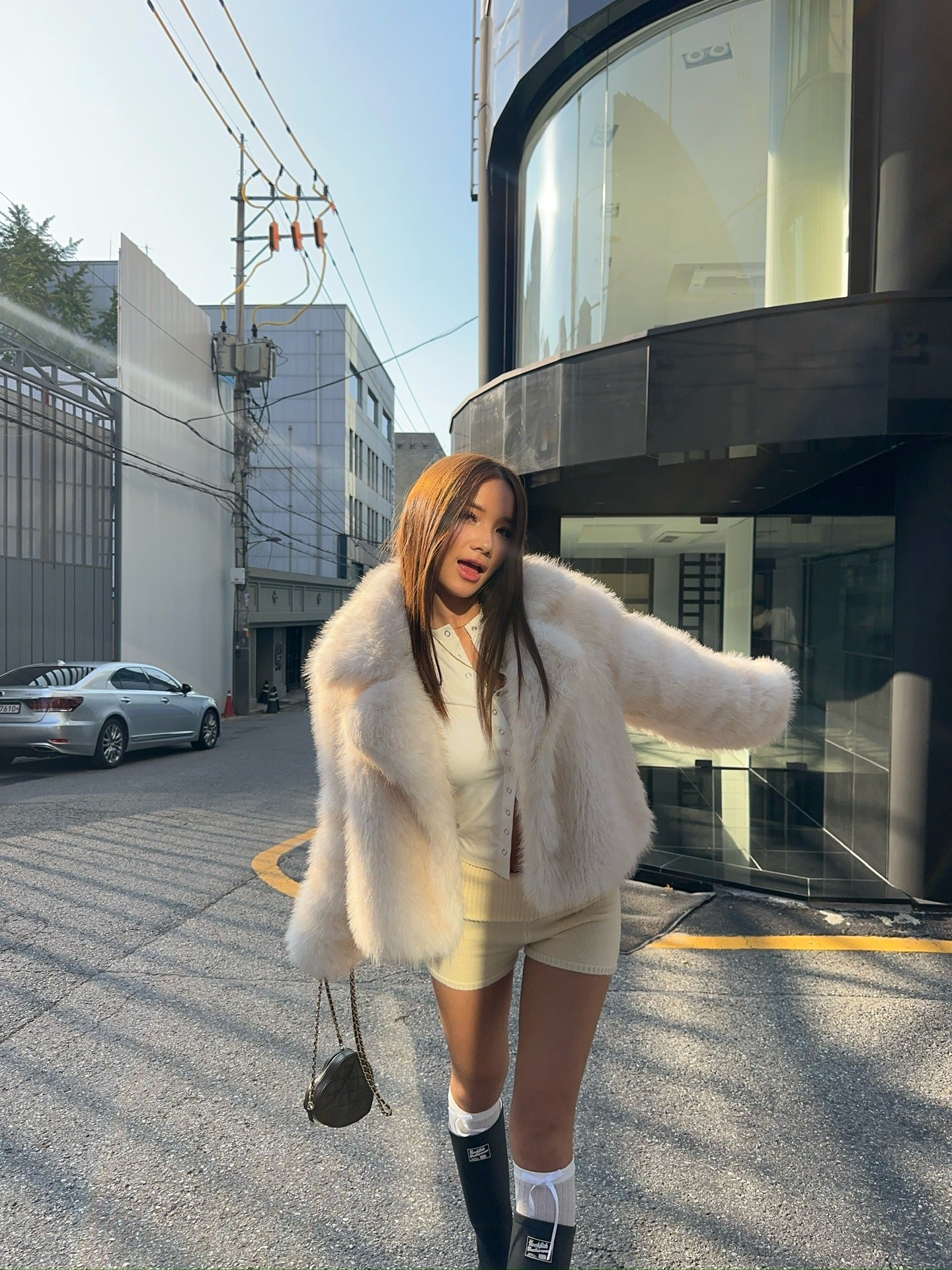 Cream faux fur oversized coat with black and white striped socks, Langry fashion