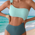 Mint green and teal textured one-piece swimsuit with cutout, a stylish fashion choice