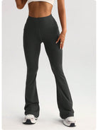 High-waisted dark gray flared langry yoga pants in stretchy fabric with side pockets