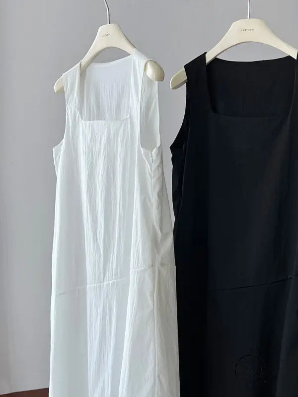 Elegant Korean style dresses: white and black sleeveless on hangers