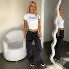 Person in white crop top and vintage pocket washed jeans