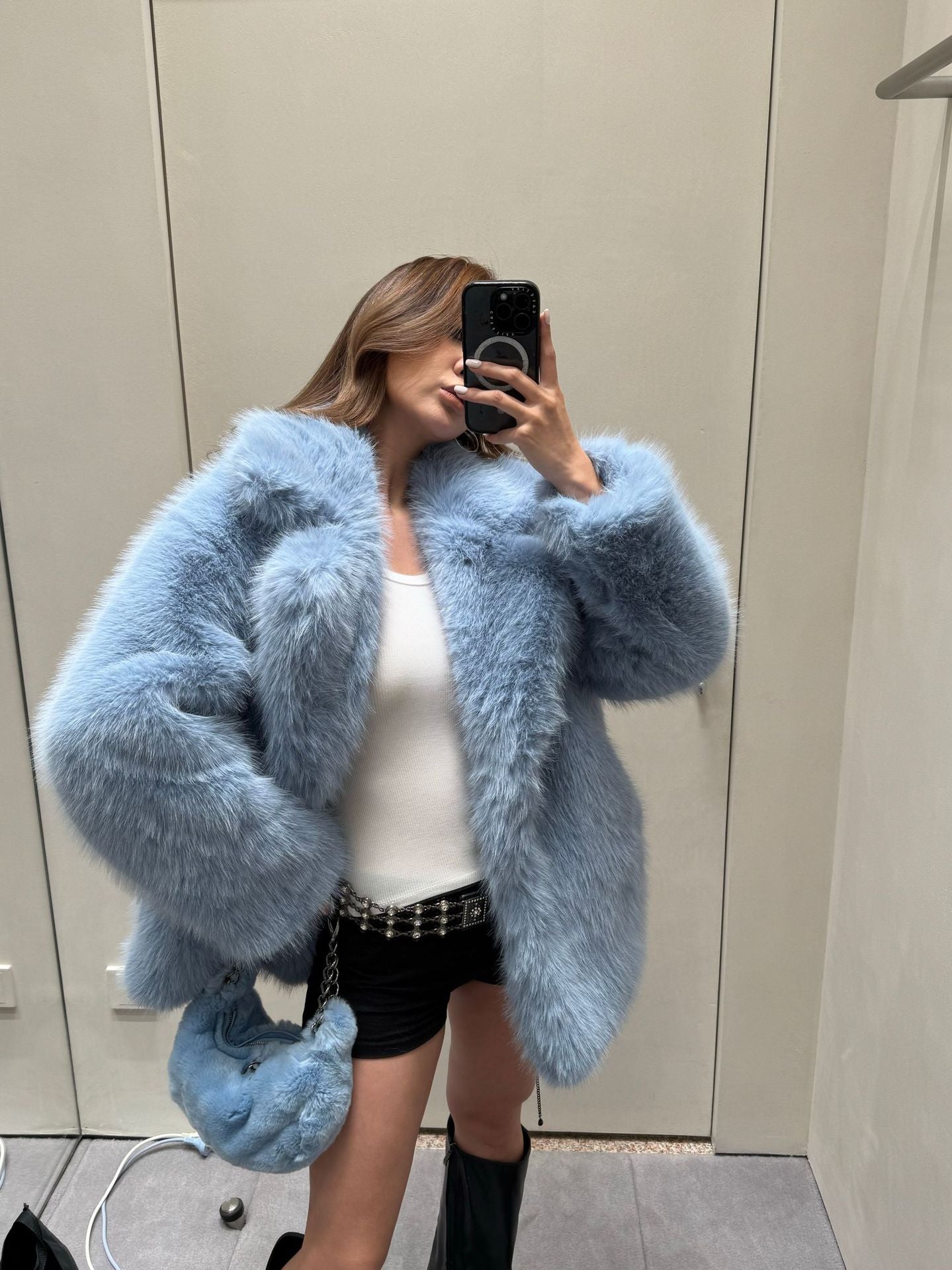 Light blue faux fur coat with oversized sleeves and plush texture