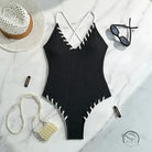 Stunning matching sling swimwear: black ribbed one-piece with white stitching