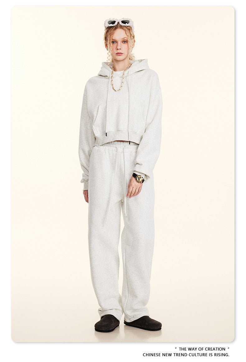 All-white sweatsuit ensemble featuring a hooded top and loose-fitting pants for winter fashion