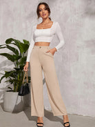 High-waisted beige wide-leg trousers with side pockets for elegant casual fashion ملابس