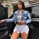 Woman in loose short denim coat with white lace top and shorts