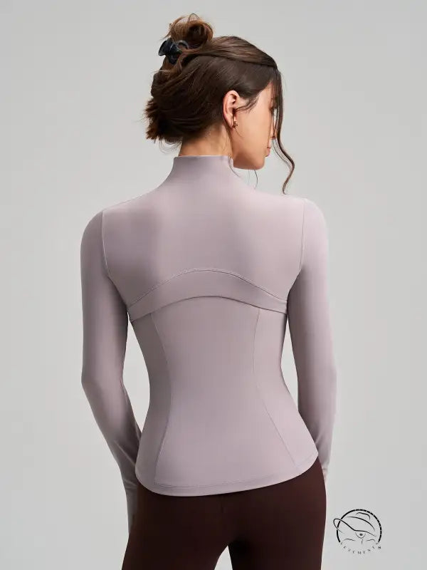 Long sleeve lavender yoga jacket with high neckline and fitted stretchy design