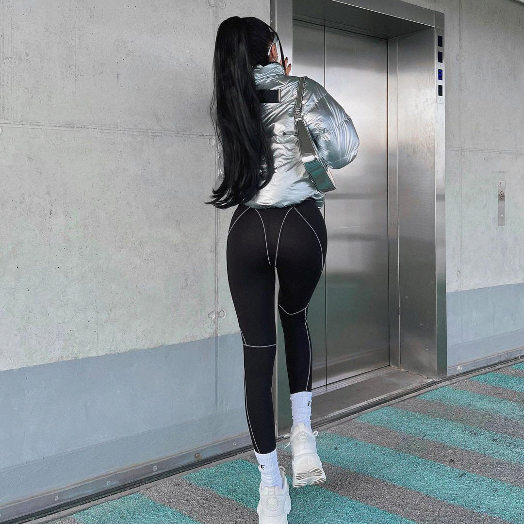 Woman wearing black leggings and silver jacket showcasing Yoga Primer Skinny Trousers