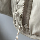 White plastic zipper and pull cord on beige fabric of Langry Winter Korean vest