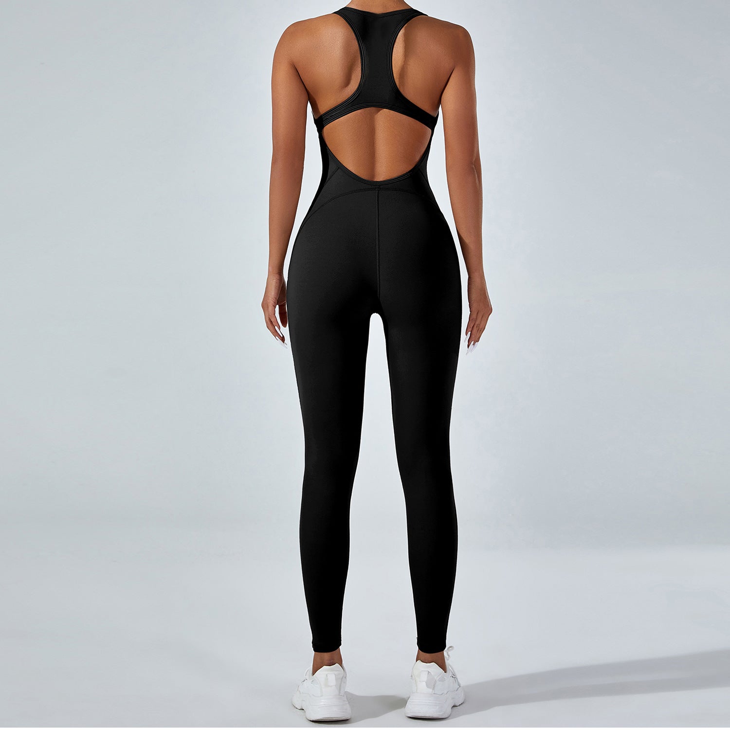 Langry yoga one-piece jumpsuit in black racerback fashion with open back cutout