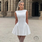 Sleeveless white mini dress in langry fashion with fitted bodice and flared skirt