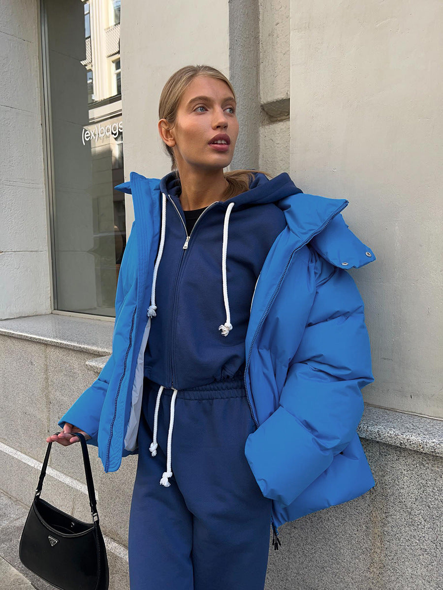 Woman in blue puffer jacket and matching tracksuit showcasing Langry fashion ملابس