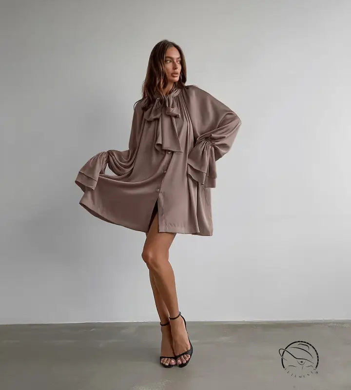 Elegant flowy taupe satin dress with oversized bow and billowing sleeves