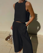 Black sleeveless crop top and wide-leg pants set for stylish casual fashion ملابس
