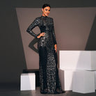 Elegant long-sleeved black gown with silver embellishments, perfect for fashion and evening events