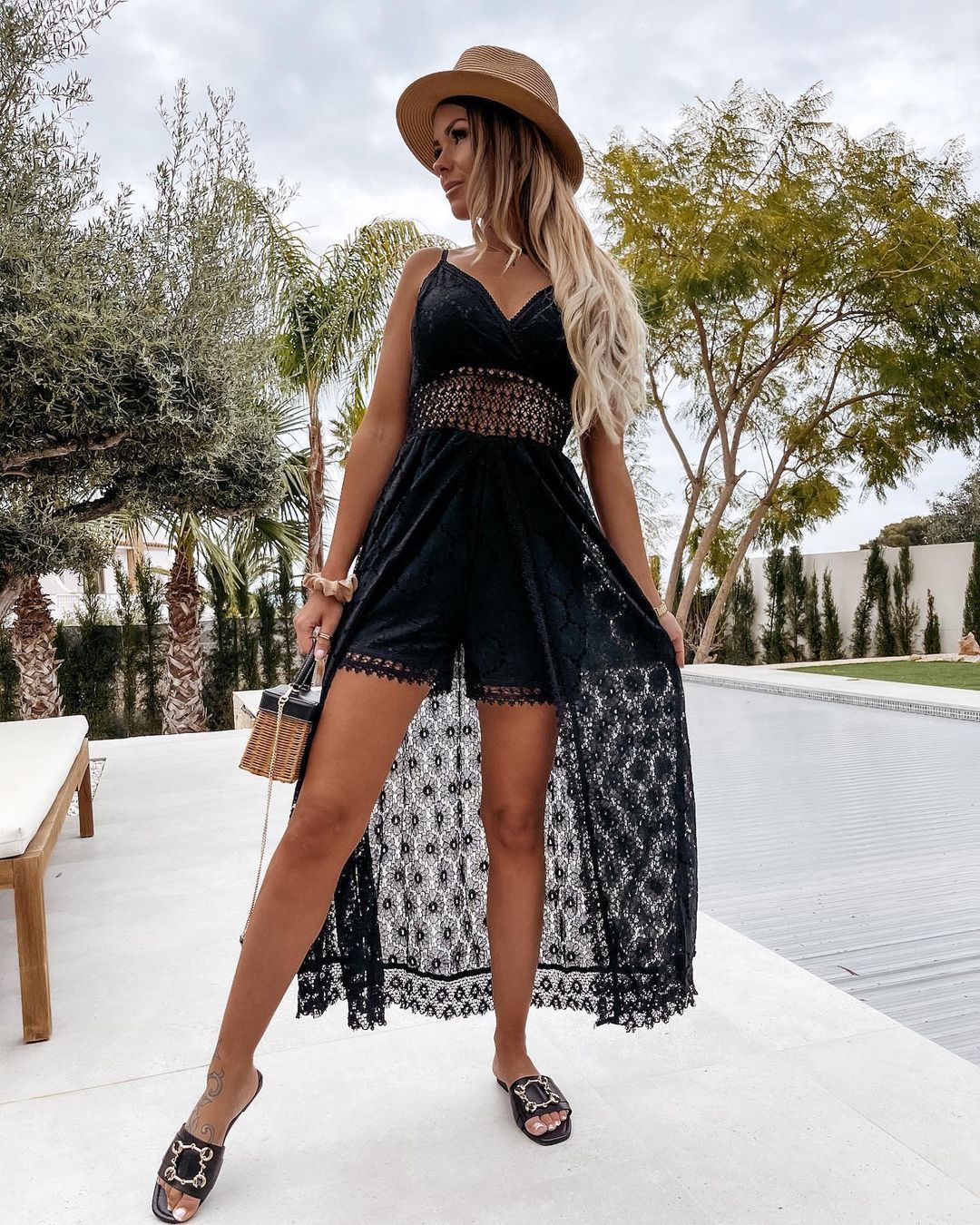 Black lace high-low dress with spaghetti straps, perfect for elegant fashion occasions