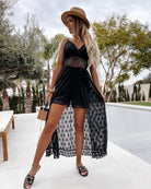 Black lace high-low dress with spaghetti straps, perfect for elegant fashion occasions