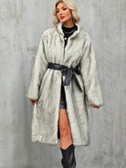 Elegant long faux fur coat with black leather belt and bow