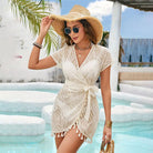 White textured wrap dress with tassel trim and short sleeves for chic beach fashion