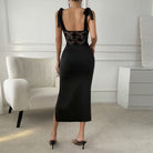 Fashionable elegant sheath dress in black lace and satin with shoulder ties