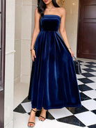 Elegant navy blue strapless velvet Langry fashion gown with fitted bodice and flared skirt