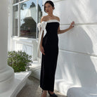 Elegant black and white strapless evening gown with a bow detail, ideal for fashion lovers