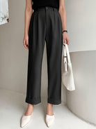Black high-waisted pleated wide leg pant with rolled cuffs for a stylish office look