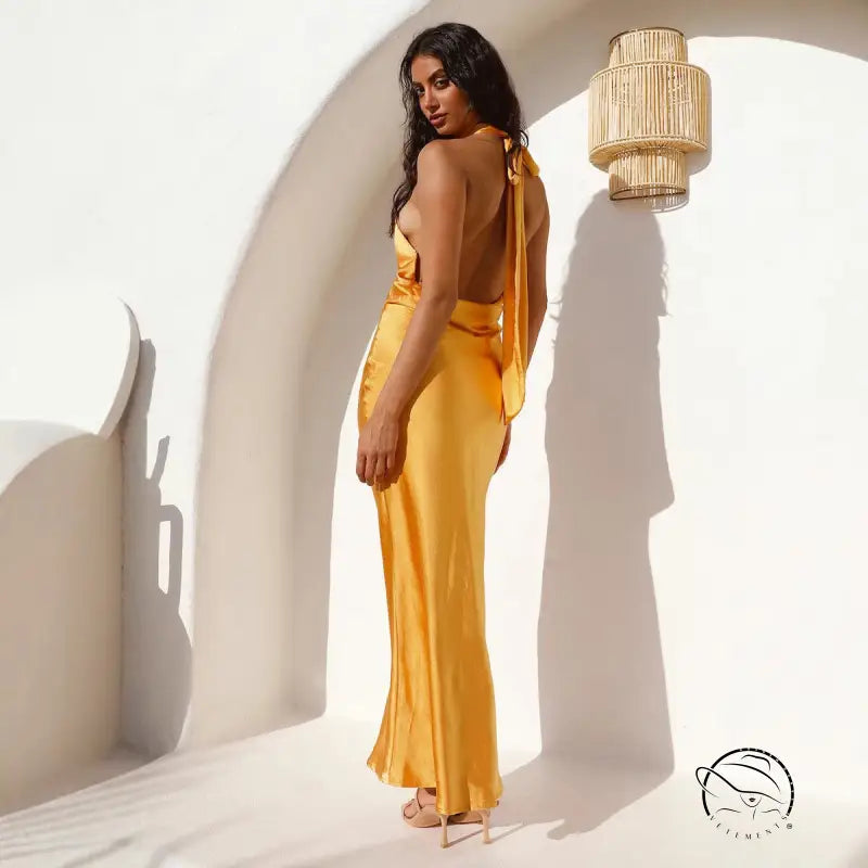 Yellow satin maxi dress with open back and halterneck straps by Langry fashion
