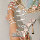 Langry silver strappy open toe stiletto heel with rhinestone bow and metallic finish
