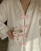 Elegant langry fashion white silk robe with pink bow accents, pearl necklace, pajamas set