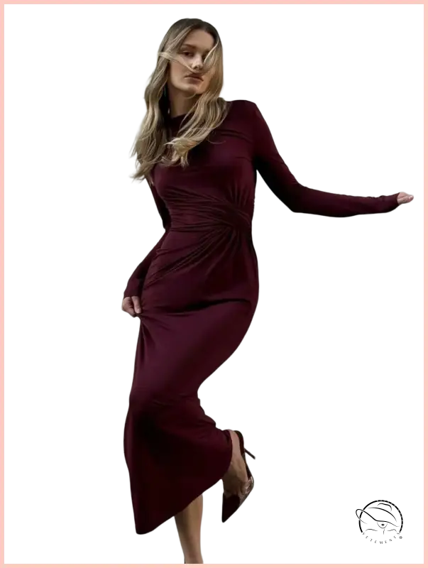 Sleek burgundy long-sleeved maxi dress with fitted draped waist
