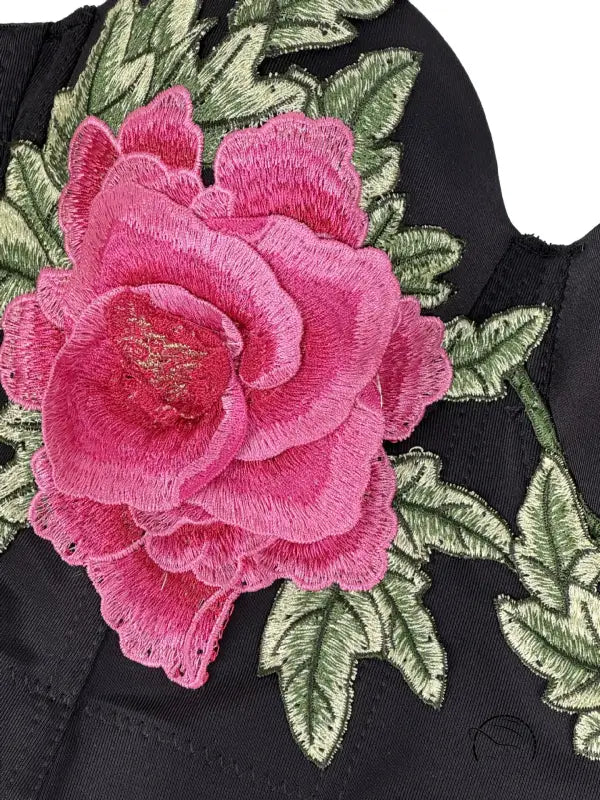 Pink rose embroidered patch on black fabric in Langry fashion corset