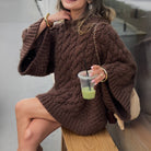 Brown cable knit oversized long sleeve sweater dress with gold hardware and chain strap