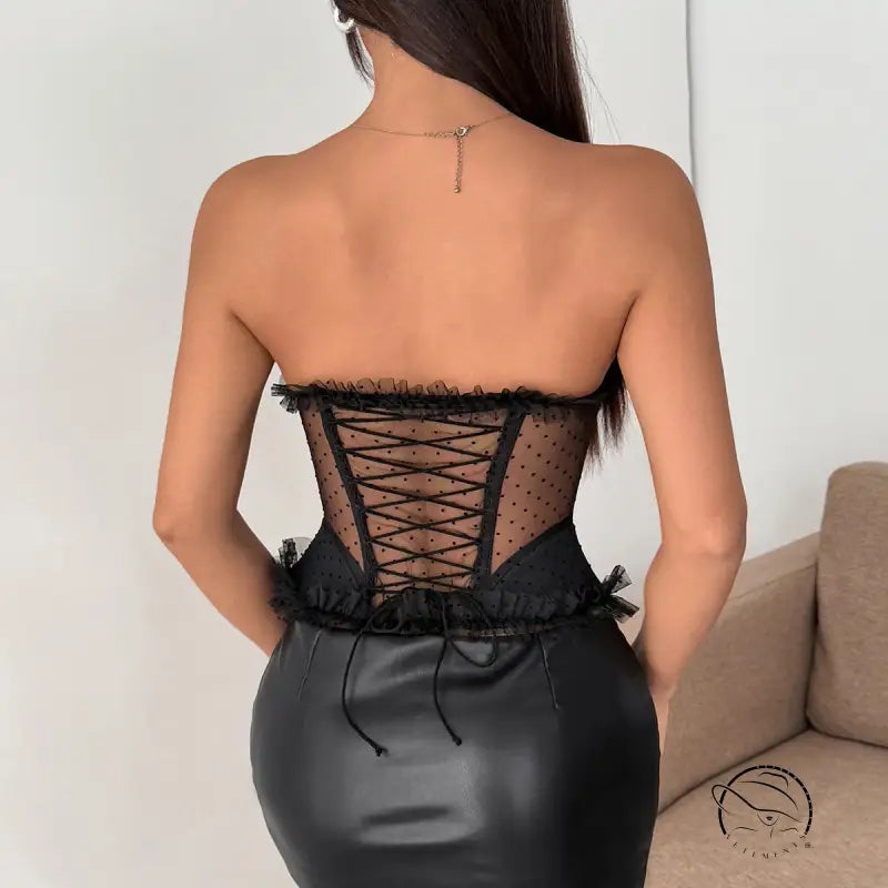 Black strapless polka dot corset dress with lace-up back and ruffled hem
