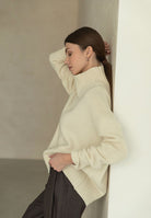 Cream-colored oversized turtleneck sweater in Langry fashion knitwear