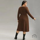Brown ribbed plus-size long-sleeve midi office dress with elastic waist and black boots