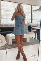 Office suspenders denim dress with ruffled hem and cowboy boots