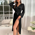 Elegant black satin wrap dress with long sleeves and high slit in langry fashion