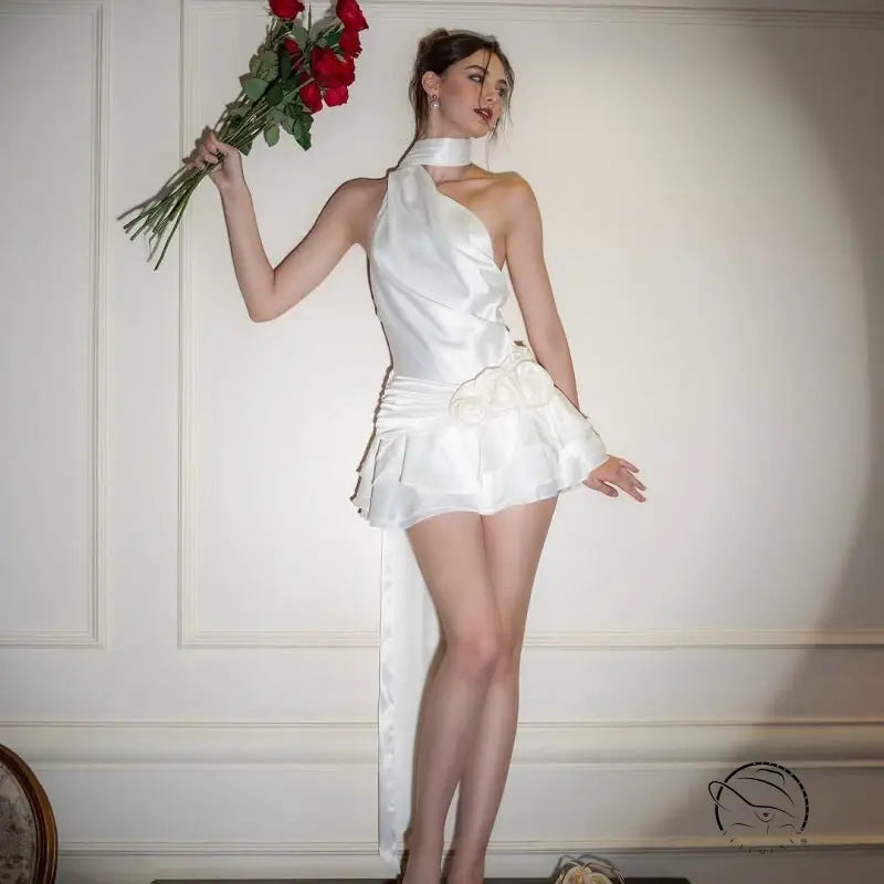 Elegant high grade off shoulder dress: woman in white asymmetrical gown holding red roses