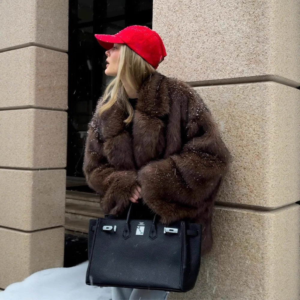 Fashionable Langry faux fur coat with black leather Hermès Birkin handbag