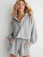 Cozy grey sweatsuit set with half-zip pullover and matching shorts for relaxed fashion