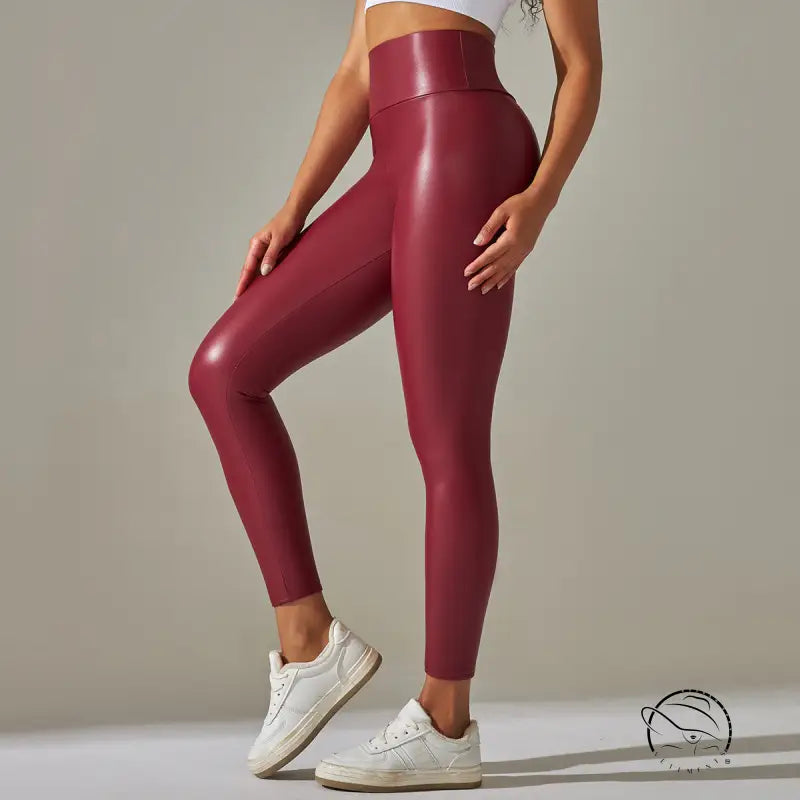Burgundy high waist faux leather leggings with white sneakers